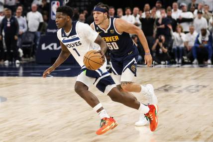 Apr 23, 2023; Minneapolis, Minnesota, USA; Minnesota Timberwolves guard Anthony Edwards (1) drives while Denver Nuggets forward Aaron Gordon (50) defends during overtime of game four of the 2023 NBA Playoffs at Target Center. Mandatory Credit: Matt Krohn-USA TODAY Sports
