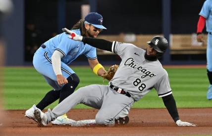 Apr 26, 2023; Toronto, Ontario, CAN;  Chicago White Sox center fielder Luis Robert Jr. (88) is tagged out at second base by Toronto Blue Jays shortstop Bo Bichette (11) in the first inning at Rogers Centre. Mandatory Credit: Dan Hamilton-USA TODAY Sports