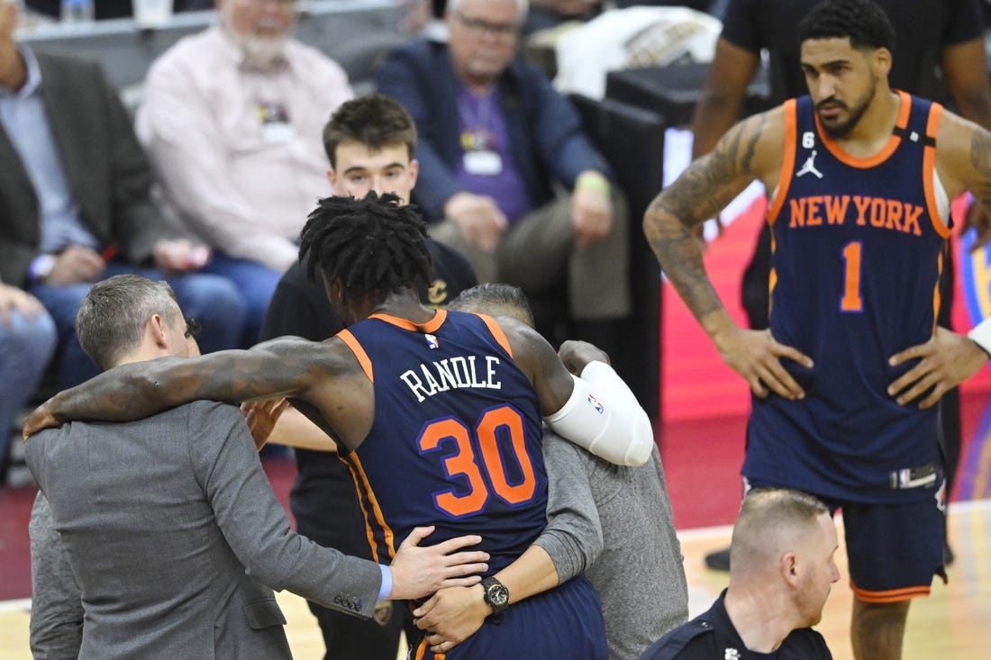 Apr 26, 2023; Cleveland, Ohio, USA; New York Knicks forward Julius Randle (30) is helped to his feet in the second quarter during game five of the 2023 NBA playoffs against the Cleveland Cavaliers at Rocket Mortgage FieldHouse. Mandatory Credit: David Richard-USA TODAY Sports