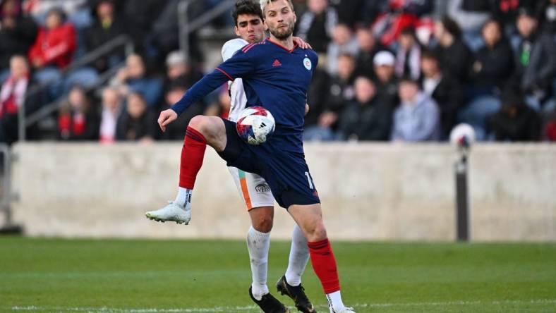 Apr 26, 2023; Bridgeview, IL, USA;  Chicago Fire FC forward Kacper Przybylko (11) takes control of the ball in front of Chicago House AC midfielder Nassouh Kabbani (15) in the first half at SeatGeek Stadium. Mandatory Credit: Jamie Sabau-USA TODAY Sports