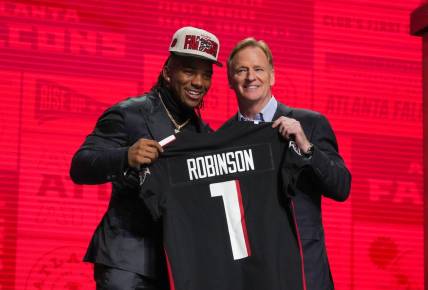 Apr 27, 2023; Kansas City, MO, USA;  Texas running back Bijan Robinson with NFL commissioner Roger Goodell after being selected by the Atlanta Falcons eighth overall in the first round of the 2023 NFL Draft at Union Station. Mandatory Credit: Kirby Lee-USA TODAY Sports