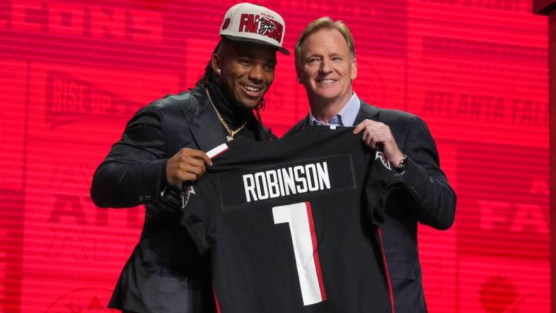 Apr 27, 2023; Kansas City, MO, USA;  Texas running back Bijan Robinson with NFL commissioner Roger Goodell after being selected by the Atlanta Falcons eighth overall in the first round of the 2023 NFL Draft at Union Station. Mandatory Credit: Kirby Lee-USA TODAY Sports