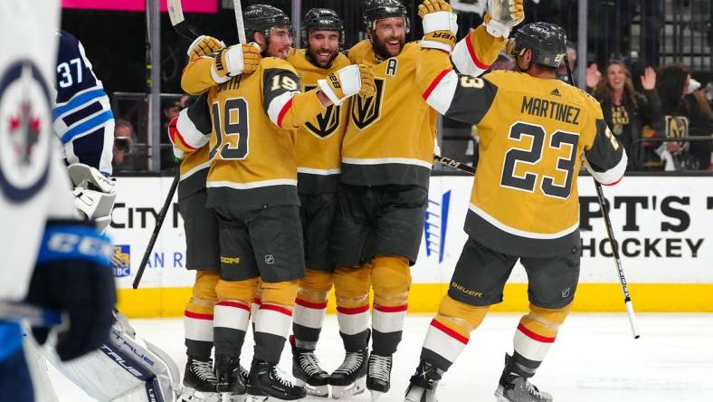 Apr 27, 2023; Las Vegas, Nevada, USA; Vegas Golden Knights right wing Reilly Smith (19), right wing Michael Amadio (22), defenseman Alex Pietrangelo (7), and defenseman Alec Martinez (23) celebrate a goal scored by center William Karlsson (71) during the second period against the Winnipeg Jets in game five of the first round of the 2023 Stanley Cup Playoffs at T-Mobile Arena. Mandatory Credit: Stephen R. Sylvanie-USA TODAY Sports