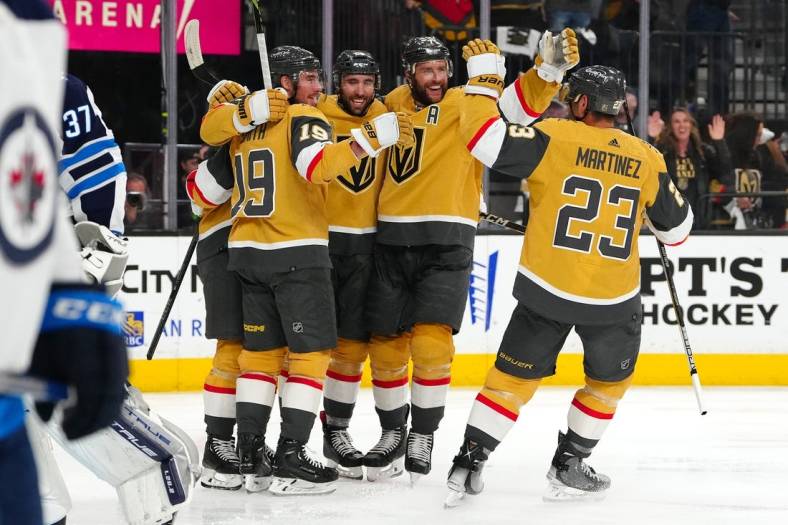 Apr 27, 2023; Las Vegas, Nevada, USA; Vegas Golden Knights right wing Reilly Smith (19), right wing Michael Amadio (22), defenseman Alex Pietrangelo (7), and defenseman Alec Martinez (23) celebrate a goal scored by center William Karlsson (71) during the second period against the Winnipeg Jets in game five of the first round of the 2023 Stanley Cup Playoffs at T-Mobile Arena. Mandatory Credit: Stephen R. Sylvanie-USA TODAY Sports