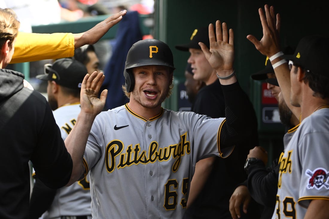 Apr 29, 2023; Washington, District of Columbia, USA; Pittsburgh Pirates center fielder Jack Suwinski (65) is congratulated by teammates after scoring a run during the eighth inning at Nationals Park. Mandatory Credit: Brad Mills-USA TODAY Sports