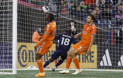 Apr 29, 2023; Foxborough, Massachusetts, USA; FC Cincinnati defender Nick Hagglund (4) and defender Ray Gaddis (28) turn away as New England Revolution midfielder Ema Boateng (18) scores during the first half at Gillette Stadium. Mandatory Credit: Winslow Townson-USA TODAY Sports