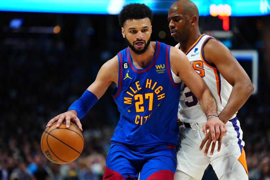 Apr 29, 2023; Denver, Colorado, USA; Denver Nuggets guard Jamal Murray (27) drives past Phoenix Suns guard Chris Paul (3) in the second half during game one of the 2023 NBA Playoffs at Ball Arena. Mandatory Credit: Ron Chenoy-USA TODAY Sports