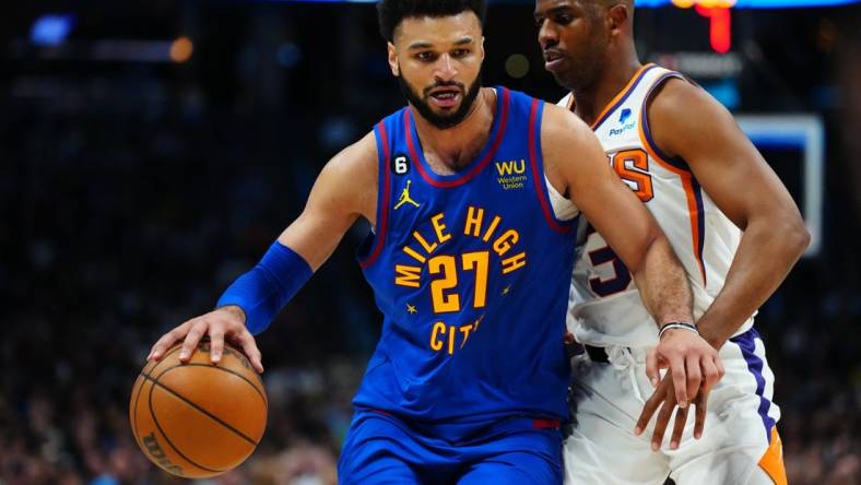 Apr 29, 2023; Denver, Colorado, USA; Denver Nuggets guard Jamal Murray (27) drives past Phoenix Suns guard Chris Paul (3) in the second half during game one of the 2023 NBA Playoffs at Ball Arena. Mandatory Credit: Ron Chenoy-USA TODAY Sports