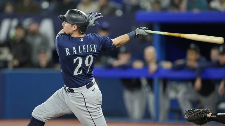 Apr 30, 2023; Toronto, Ontario, CAN; Seattle Mariners catcher Cal Raleigh (29) hits a two run home run against the Toronto Blue Jays during the tenth inning at Rogers Centre. Mandatory Credit: John E. Sokolowski-USA TODAY Sports