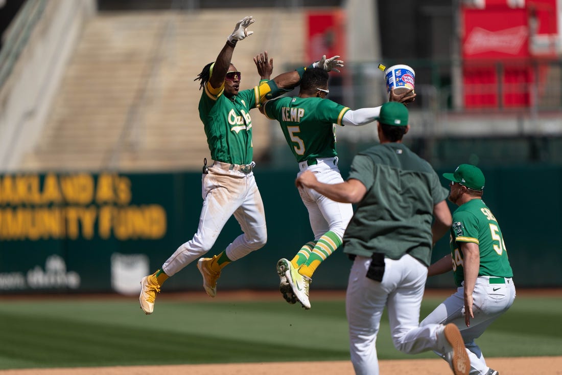 Apr 30, 2023; Oakland, California, USA;  Oakland Athletics second baseman Tony Kemp (5) celebrates with center fielder Esteury Ruiz (1) after defeating the Cincinnati Reds with a walk off single at RingCentral Coliseum. Mandatory Credit: Stan Szeto-USA TODAY Sports