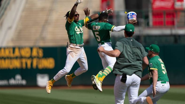 Apr 30, 2023; Oakland, California, USA;  Oakland Athletics second baseman Tony Kemp (5) celebrates with center fielder Esteury Ruiz (1) after defeating the Cincinnati Reds with a walk off single at RingCentral Coliseum. Mandatory Credit: Stan Szeto-USA TODAY Sports