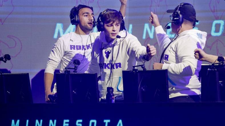 Jan 26, 2020; Minneapolis, Minnesota, USA; Obaid Asim and Alex Alexx Carpenter and Adam Assault Garcia of the Minnesota Rokkr celebrate after defeating the Toronto Ultra in a round during the Call of Duty League Launch Weekend at The Armory. Mandatory Credit: Bruce Kluckhohn-USA TODAY Sports