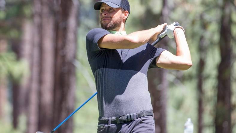 Stephen Curry swings during the ACC Golf Tournament at Edgewood Tahoe Golf Course in South Lake Tahoe on Saturday, July 11, 2020.