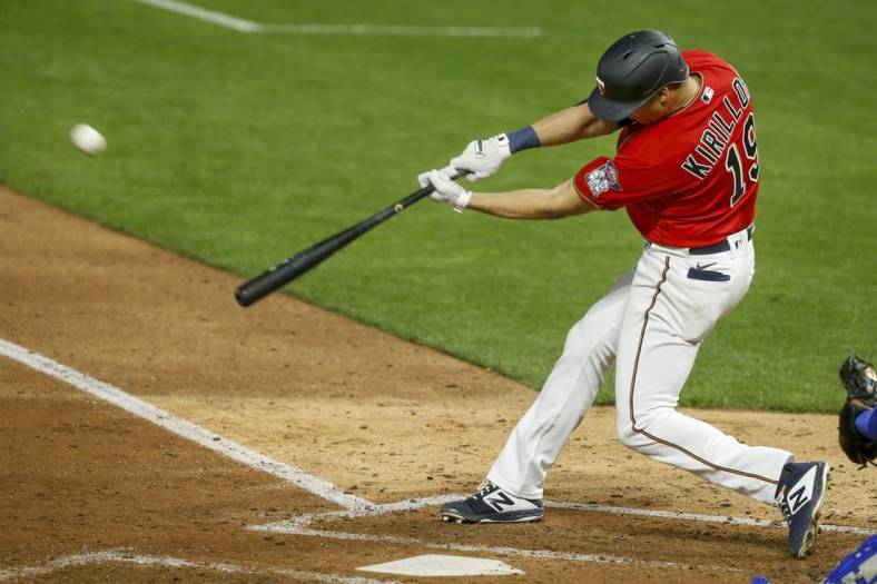 Apr 30, 2021; Minneapolis, Minnesota, USA; Minnesota Twins first baseman Alex Kiriloff (19) hits a solo home run against the Kansas City Royals manager Mike Matheny in the fifth inning at Target Field. Mandatory Credit: Bruce Kluckhohn-USA TODAY Sports