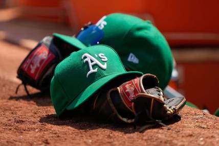 Aug 8, 2021; Oakland, California, USA;  General view of the Oakland Athletics hat and glove during the fifth inning against the Texas Rangers at RingCentral Coliseum. Mandatory Credit: Stan Szeto-USA TODAY Sports