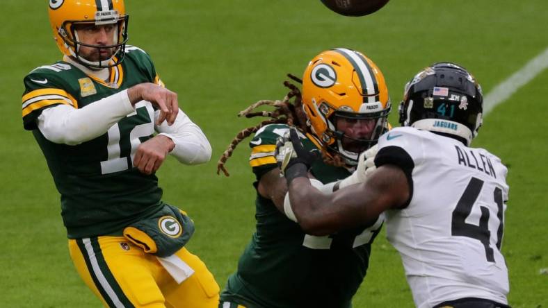 Green Bay Packers quarterback Aaron Rodgers (12) rifles a pass while Green Bay Packers offensive tackle Billy Turner (77) blocks Jacksonville Jaguars defensive end Josh Allen (41) the second quarter of their game at Lambeau Field in Green Bay, Wis.

Mjs Jenkins 6 Jpg Packers16