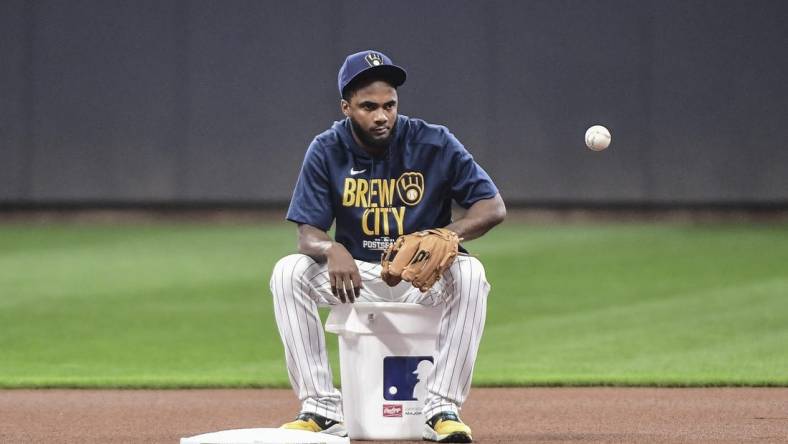 Oct 7, 2021; Milwaukee, WI, USA;  Milwaukee Brewers infielder Pablo Reyes gathers balls during NLDS workouts. Mandatory Credit: Benny Sieu-USA TODAY Sports