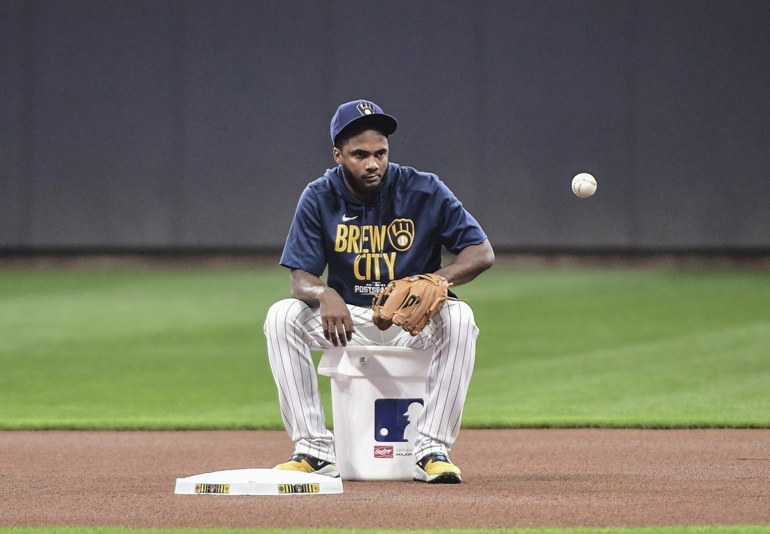 Oct 7, 2021; Milwaukee, WI, USA;  Milwaukee Brewers infielder Pablo Reyes gathers balls during NLDS workouts. Mandatory Credit: Benny Sieu-USA TODAY Sports