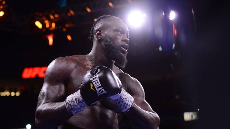 Oct 9, 2021; Las Vegas, Nevada, USA; Deontay Wilder (red/black trunks) and Tyson Fury (black/gold trunks) box during their WBC/Lineal heavyweight championship boxing match at T-Mobile Arena. Mandatory Credit: Joe Camporeale-USA TODAY Sports