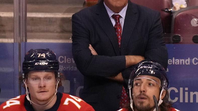 Oct 16, 2021; Sunrise, Florida, USA; Florida Panthers head coach Joel Quenneville watches the game behind right wing Owen Tippett (74) and left wing Ryan Lomberg (94) during the third period against the New York Islanders at FLA Live Arena. Mandatory Credit: Jasen Vinlove-USA TODAY Sports