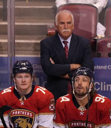 Oct 16, 2021; Sunrise, Florida, USA; Florida Panthers head coach Joel Quenneville watches the game behind right wing Owen Tippett (74) and left wing Ryan Lomberg (94) during the third period against the New York Islanders at FLA Live Arena. Mandatory Credit: Jasen Vinlove-USA TODAY Sports