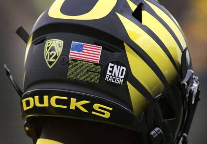 An "End racism" sticker joins the American Flag on the helmets of Oregon players Saturday Oct. 30, 2021.

Eug 103021 Uo Cofb03