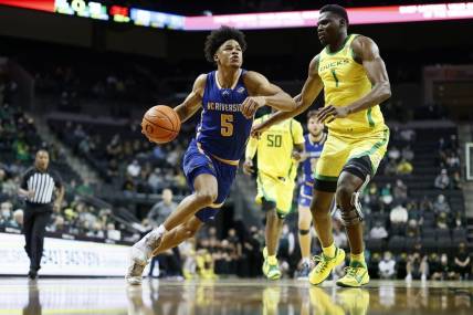 Dec 1, 2021; Eugene, Oregon, USA; UC Riverside Highlanders guard Zyon Pullin (5) drives to the basket against Oregon Ducks center N'Faly Dante (1) during the second half at Matthew Knight Arena. Mandatory Credit: Soobum Im-USA TODAY Sports