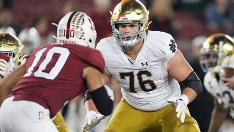 Nov 27, 2021; Stanford, California, USA; Notre Dame Fighting Irish offensive lineman Joe Alt (76) blocks Stanford Cardinal linebacker Jordan Fox (10) during the fourth quarter at Stanford Stadium. Mandatory Credit: Darren Yamashita-USA TODAY Sports