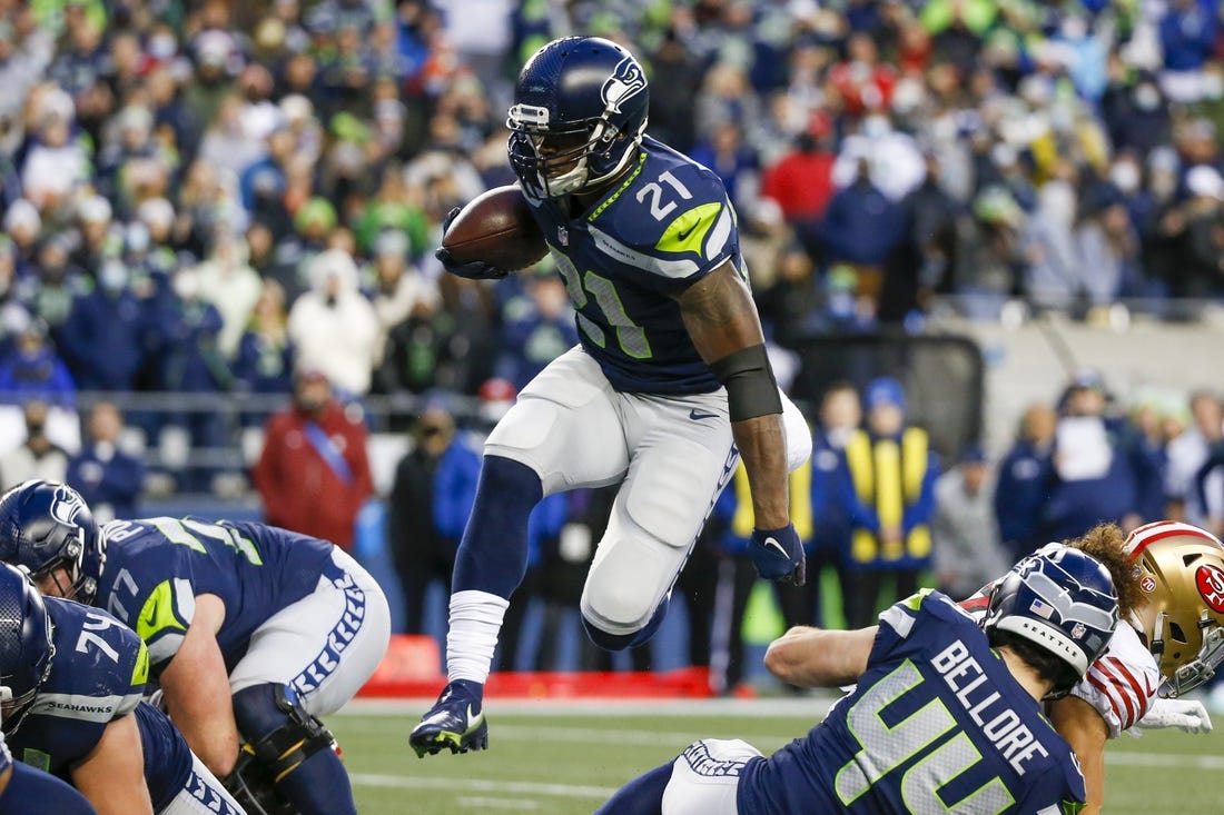 Dec 5, 2021; Seattle, Washington, USA; Seattle Seahawks running back Adrian Peterson (21) rushes against the San Francisco 49ers during the fourth quarter at Lumen Field. Mandatory Credit: Joe Nicholson-USA TODAY Sports