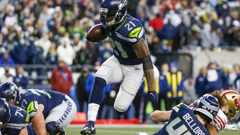 Dec 5, 2021; Seattle, Washington, USA; Seattle Seahawks running back Adrian Peterson (21) rushes against the San Francisco 49ers during the fourth quarter at Lumen Field. Mandatory Credit: Joe Nicholson-USA TODAY Sports