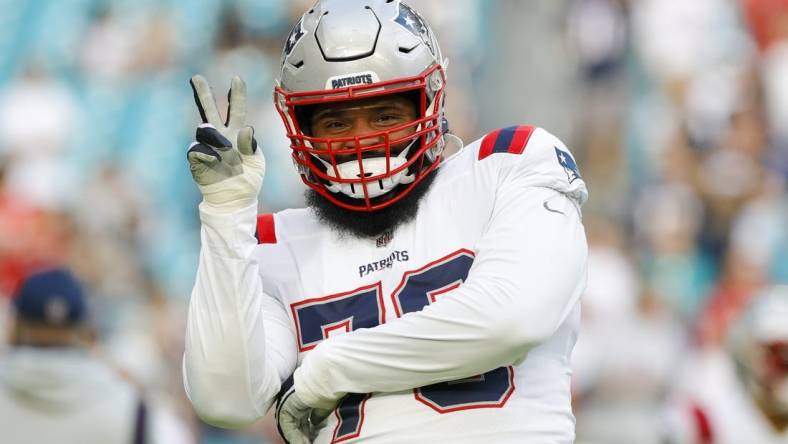 Jan 9, 2022; Miami Gardens, Florida, USA; New England Patriots offensive tackle Isaiah Wynn (76) reacts from the field prior to the game against the Miami Dolphins at Hard Rock Stadium. Mandatory Credit: Sam Navarro-USA TODAY Sports