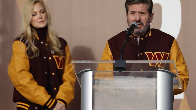 Feb 2, 2022; Landover, MD, USA; Washington Commanders co-owner Dan Snyder speaks as co-owner Tanya Snyder (L) listens during a press conference revealing the Commanders as the new name for the formerly named Washington Football Team at FedEx Field. Mandatory Credit: Geoff Burke-USA TODAY Sports