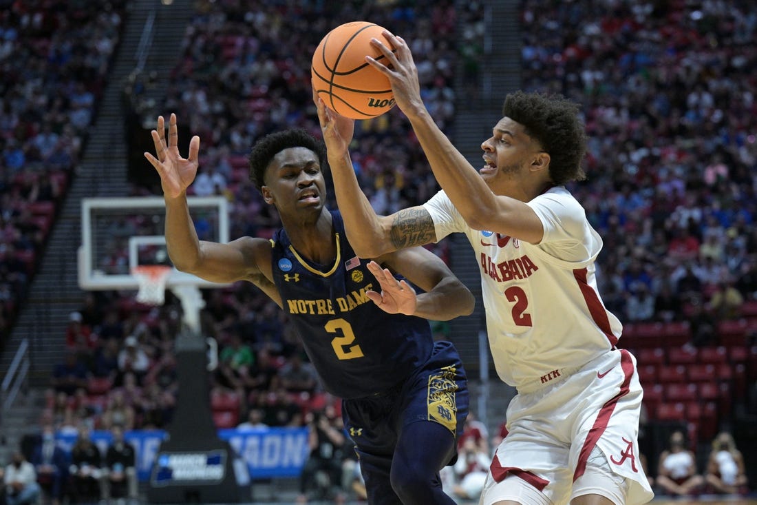 Mar 18, 2022; San Diego, CA, USA; Alabama Crimson Tide forward Darius Miles (2) controls the ball against Notre Dame Fighting Irish guard Trey Wertz (2) in the first half during the first round of the 2022 NCAA Tournament at Viejas Arena. Mandatory Credit: Orlando Ramirez-USA TODAY Sports