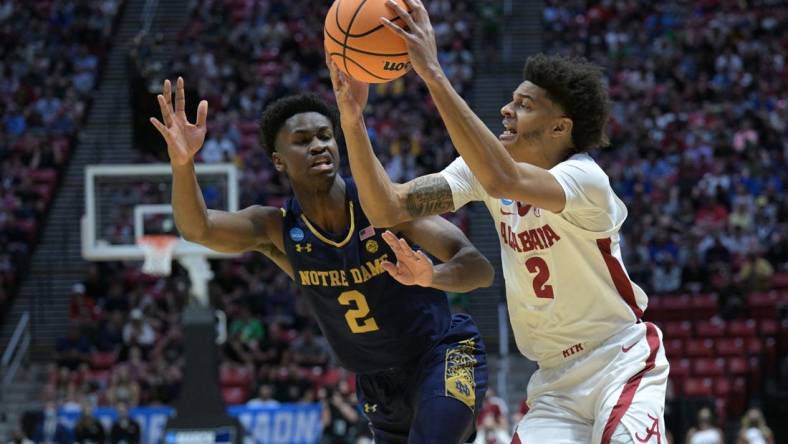 Mar 18, 2022; San Diego, CA, USA; Alabama Crimson Tide forward Darius Miles (2) controls the ball against Notre Dame Fighting Irish guard Trey Wertz (2) in the first half during the first round of the 2022 NCAA Tournament at Viejas Arena. Mandatory Credit: Orlando Ramirez-USA TODAY Sports