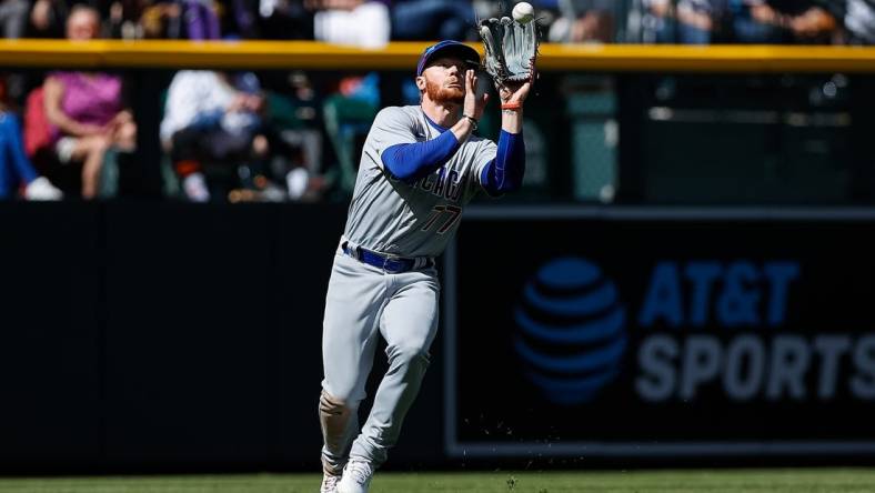 Apr 17, 2022; Denver, Colorado, USA; Chicago Cubs left fielder Clint Frazier (77) makes a catch for an out in the fifth inning against the Colorado Rockies at Coors Field. Mandatory Credit: Isaiah J. Downing-USA TODAY Sports