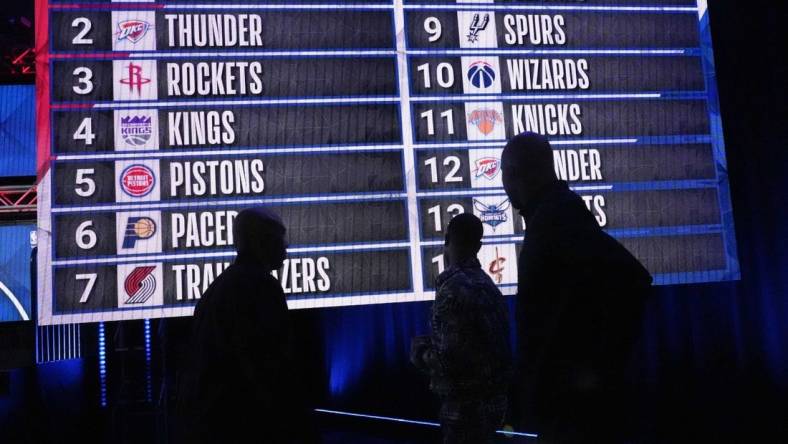 May 17, 2022; Chicago, IL, USA; People look at the draft lottery order after the 2022 NBA Draft Lottery at McCormick Place. Mandatory Credit: David Banks-USA TODAY Sports