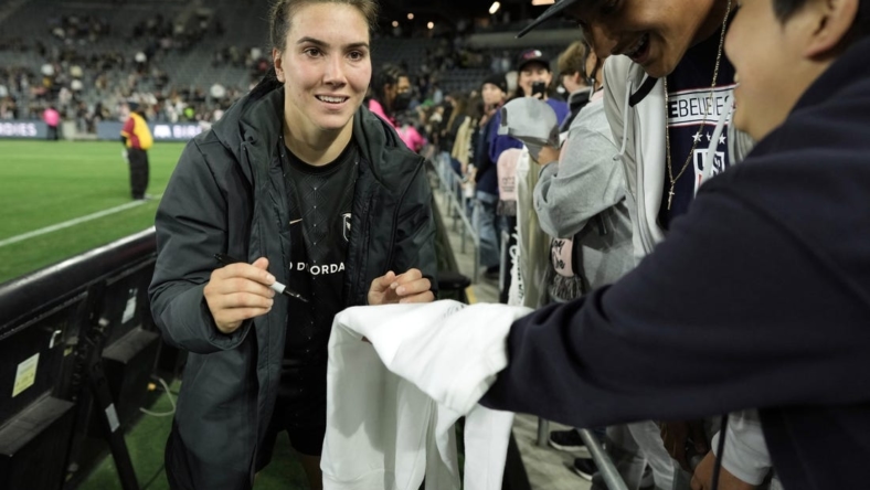 May 21, 2022; Los Angeles, California, USA; Angel City FC defender Vanessa Giles (4) signs autographs after the win against the Kansas City Current at Banc of California Stadium. Mandatory Credit: Kirby Lee-USA TODAY Sports
