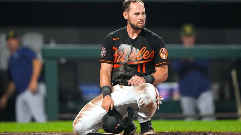 May 20, 2022; Baltimore, Maryland, USA; Baltimore Orioles second baseman Chris Owings (11) reacts to being tagged out a home plate during the fifth inning against the Tampa Bay Rays at Oriole Park at Camden Yards. Mandatory Credit: Gregory Fisher-USA TODAY Sports