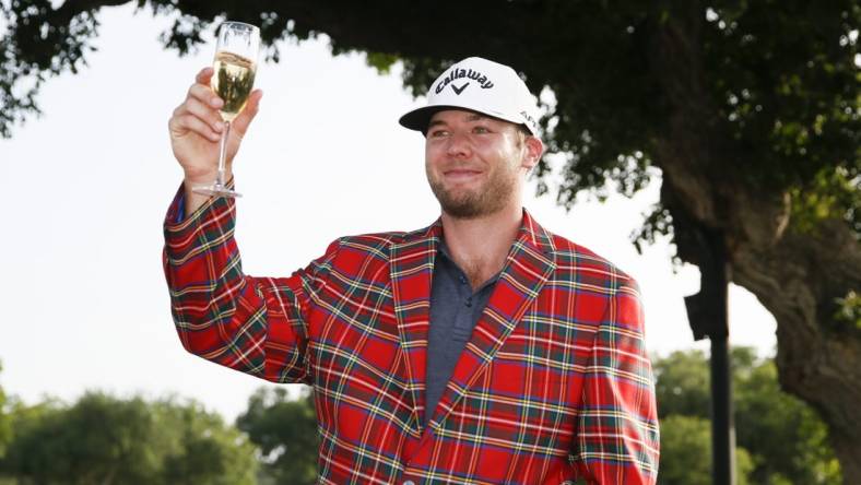 May 29, 2022; Fort Worth, Texas, USA; Sams Burns toasts to his victory following the final round of the Charles Schwab Challenge golf tournament. Mandatory Credit: Raymond Carlin III-USA TODAY Sports