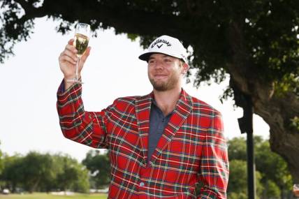 May 29, 2022; Fort Worth, Texas, USA; Sams Burns toasts to his victory following the final round of the Charles Schwab Challenge golf tournament. Mandatory Credit: Raymond Carlin III-USA TODAY Sports