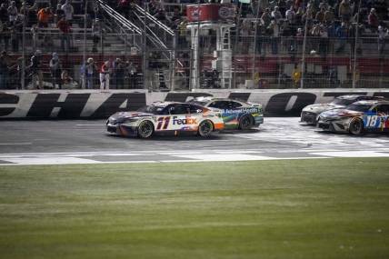 May 29, 2022; Concord, North Carolina, USA; NASCAR Cup Series driver Denny Hamlin (11) takes the lead on the restart in the Coca-Cola 600 at Charlotte Motor Speedway. Mandatory Credit: Jim Dedmon-USA TODAY Sports