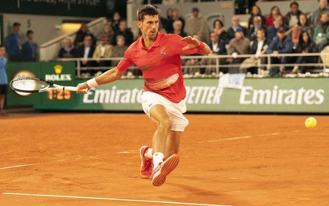 May 31, 2022; Paris, France; Novak Djokovic (SRB) returns a shot during his match against Rafael Nadal (ESP) on day 10 of the French Open at Stade Roland-Garros. Mandatory Credit: Susan Mullane-USA TODAY Sports