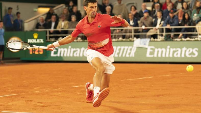 May 31, 2022; Paris, France; Novak Djokovic (SRB) returns a shot during his match against Rafael Nadal (ESP) on day 10 of the French Open at Stade Roland-Garros. Mandatory Credit: Susan Mullane-USA TODAY Sports