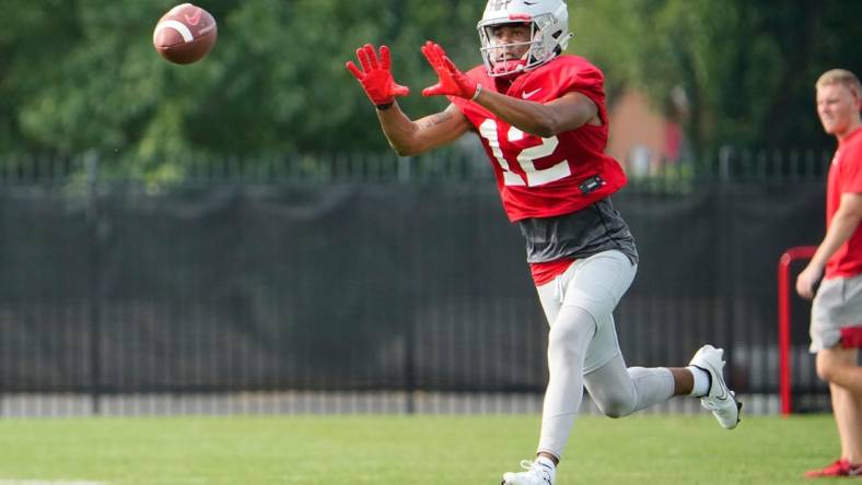 Aug 4, 2022; Columbus, OH, USA;  Ohio State Buckeyes wide receiver Caleb Burton (12) catches a pass during the first fall football practice at the Woody Hayes Athletic Center. Mandatory Credit: Adam Cairns-The Columbus Dispatch

Ohio State Football First Practice