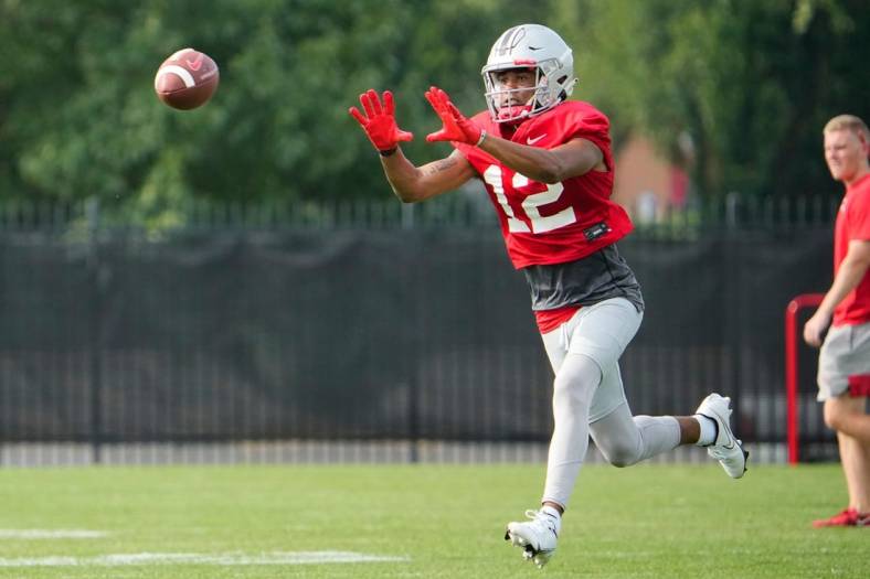 Aug 4, 2022; Columbus, OH, USA;  Ohio State Buckeyes wide receiver Caleb Burton (12) catches a pass during the first fall football practice at the Woody Hayes Athletic Center. Mandatory Credit: Adam Cairns-The Columbus Dispatch

Ohio State Football First Practice