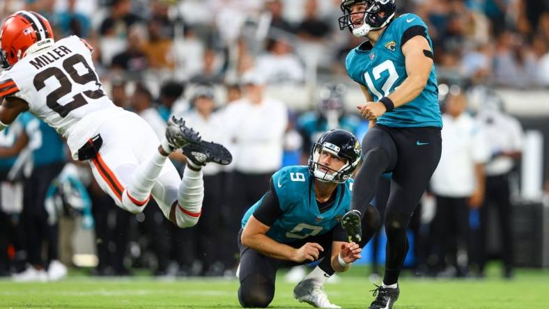 Aug 12, 2022; Jacksonville, Florida, USA; Jacksonville Jaguars place kicker Elliott Fry (12) kicks an extra point against the Cleveland Browns in the second quarter during preseason at TIAA Bank Field. Mandatory Credit: Nathan Ray Seebeck-USA TODAY Sports