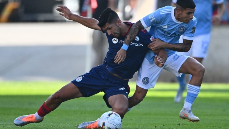 Aug 21, 2022; Chicago, Illinois, USA;  Chicago Fire FC defender Mauricio Pineda (22) is pulled down by New York City FC midfielder Santiago Rodriguez (20) in the first half at Bridgeview Stadium. Mandatory Credit: Jamie Sabau-USA TODAY Sports