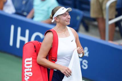 Aug 30, 2022; Flushing, NY, USA; Amanda Anisimova of the United States reacts as she walks off the court after losing her first round match to Yulia Putintseva of Kazakhstan on day two of the 2022 U.S. Open tennis tournament at USTA Billie Jean King National Tennis Center. Mandatory Credit: Danielle Parhizkaran-USA TODAY Sports