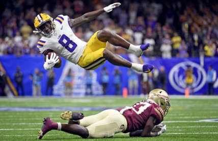 Sep 4, 2022; New Orleans, Louisiana, USA; Louisiana State Tigers wide receiver Malik Nabers (8) goes airborne as he is tackled by Florida State Seminoles defensive back Omarion Cooper (13) during the second half at Caesars Superdome. Mandatory Credit: Melina Myers-USA TODAY Sports