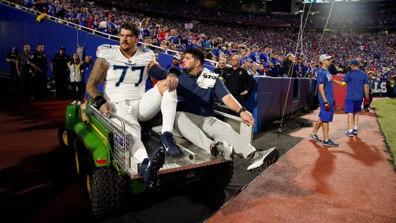 Tennessee Titans offensive tackle Taylor Lewan (77) is helped from the field after getting hurt during the first quarter against the Buffalo Bills at Highmark Stadium Monday, Sept. 19, 2022, in Orchard Park, New York.

Nfl Tennessee Titans At Buffalo Bills